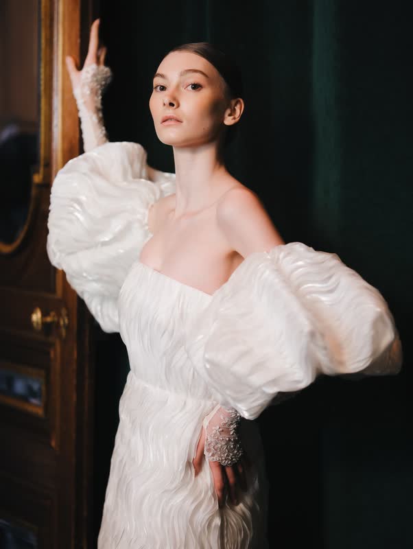 Model in a pale puff-sleeved gown